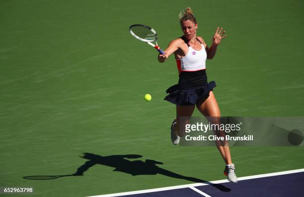 Pauline Parmentier of France plays a forehand against Angelique Kerber of Germany in their third round match during day eight of the BNP Paribas Open...