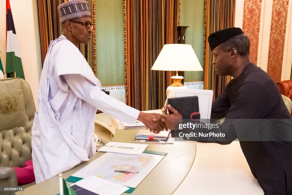 Nigeria's president Muhammadu Buhari welcomes Vice President Yemi Osinbajo