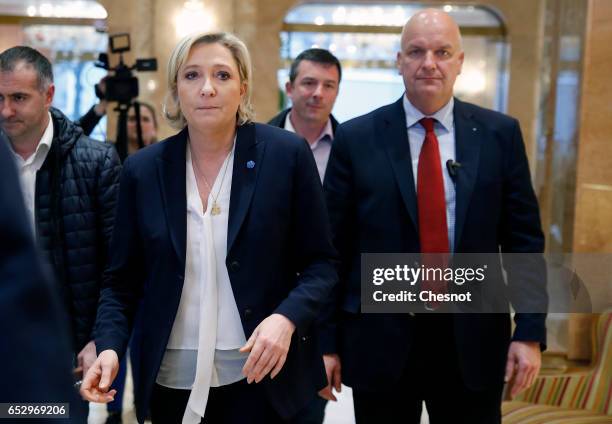 French far-right political party National Front President, Marine Le Pen flanked by her bodyguard Thierry Legier arrives to attend a press conference...