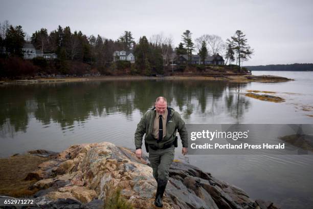 Dan Devereaux walks along the rocks at Mere Point Boat Launch. Devereaux is the Marine Resource Officer and Harbor Master for the town of Brunswick.