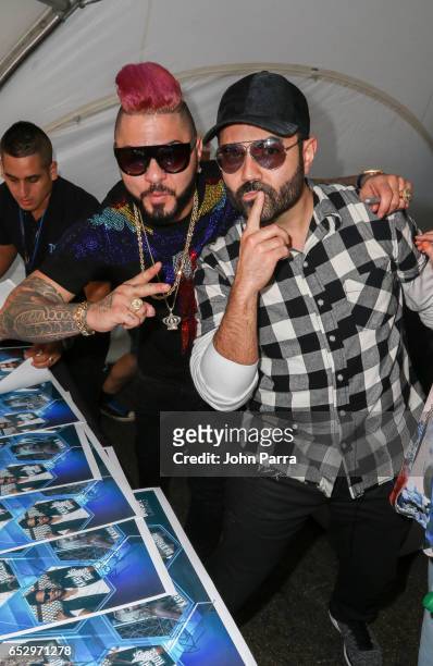 Chacal and Enrique Santos backstage during the iHeartLatino TU94.9FM Calle Ocho festival on March 12, 2017 in Miami, Florida.