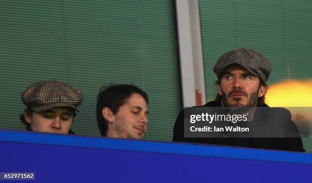 David and Brooklyn Beckham look on from the stands prior to The Emirates FA Cup Quarter-Final match between Chelsea and Manchester United at Stamford...