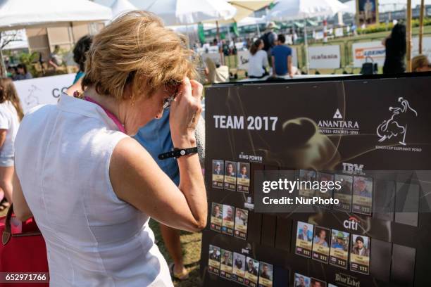 Visitor reads programm of the 2017 King's Cup Elephant Polo tournament at Anantara Chaopraya Resort in Bangkok, Thailand on March 12, 2017. The...