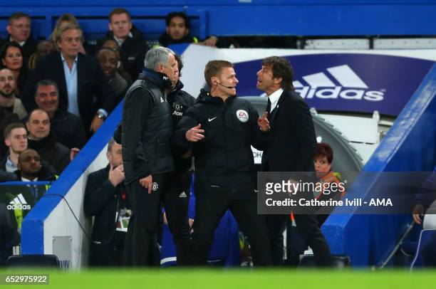 Jose Mourinho Manager of Manchester United and Antonio Conte manager of Chelsea have words and are separated by fourth official Mike Jones during The...