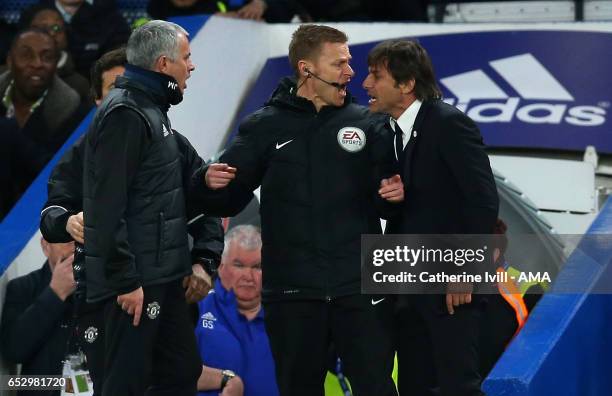 Jose Mourinho Manager of Manchester United and Antonio Conte manager of Chelsea have words and are separated by fourth official Mike Jones during The...