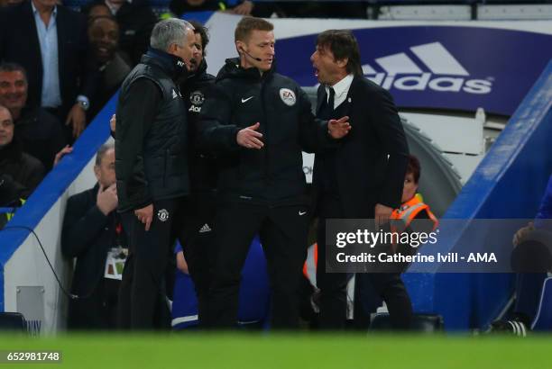 Jose Mourinho Manager of Manchester United and Antonio Conte manager of Chelsea have words and are separated by fourth official Mike Jones during The...