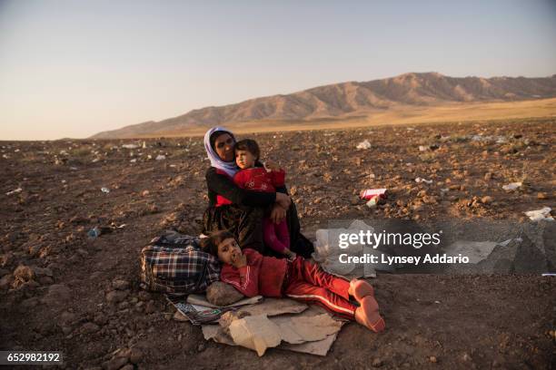 Iraqi Yazidi families camp out near Bahjad Kandal camp close to the Iraqi border with Syria, in Northern Iraq, August 16, 2014. Since IS started...