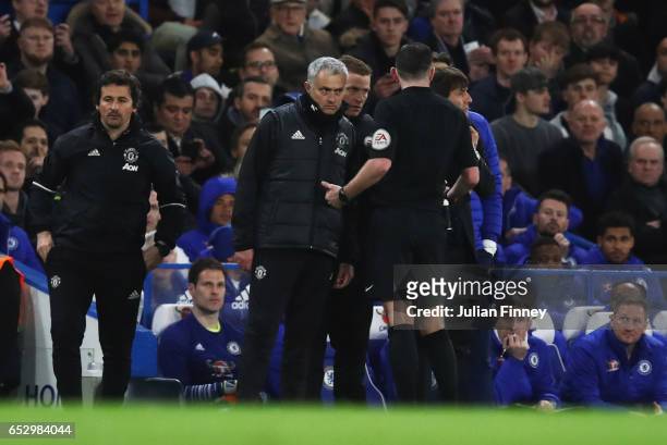 Referee Michael Oliver speaks to Jose Mourinho manager of Manchester United and Antonio Conte manager of Chelsea as they clash during The Emirates FA...