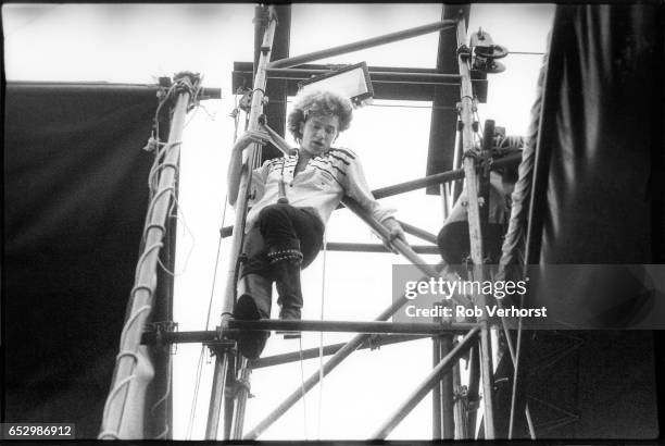 Bono of U2 climbs up stage scaffolding while performing during the 'October' tour at Torhout festival, Belgium, 3rd July 1982.