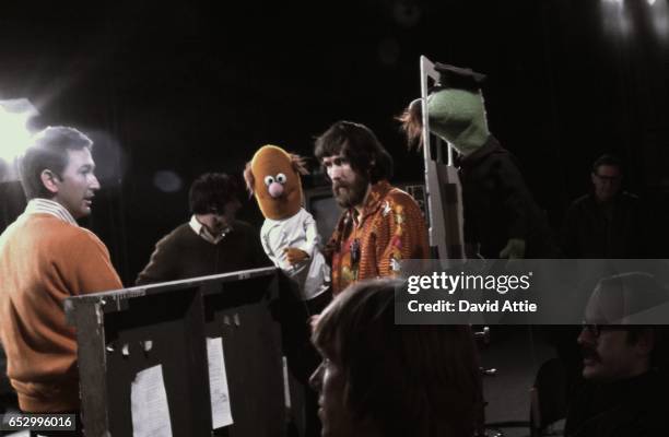 Puppeteers Jim Henson holding an 'Anything Muppet' Doctor and frank Oz with an 'Anything Muppet' postman rehearse for an episode of Sesame Street at...