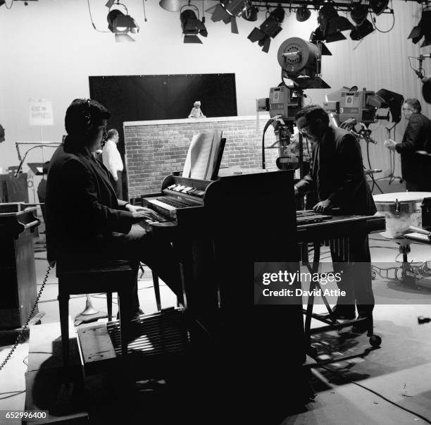 Puppeteer Jim Henson and organist, Joe Raposo rehearse for an episode of Sesame Street at Reeves TeleTape Studio in 1970 in New York City, New York.