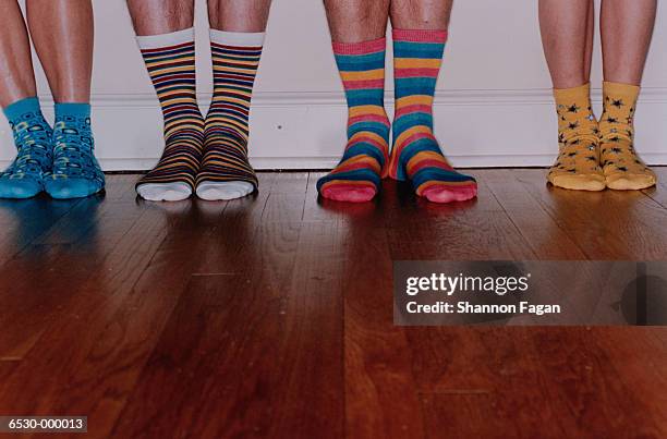 feet in assortment of socks - tabla de piso fotografías e imágenes de stock
