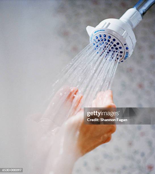 cupped hands under shower - douche stockfoto's en -beelden