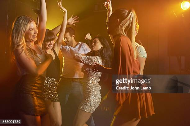 group of friends dancing in a nightclub - disco lights stock pictures, royalty-free photos & images