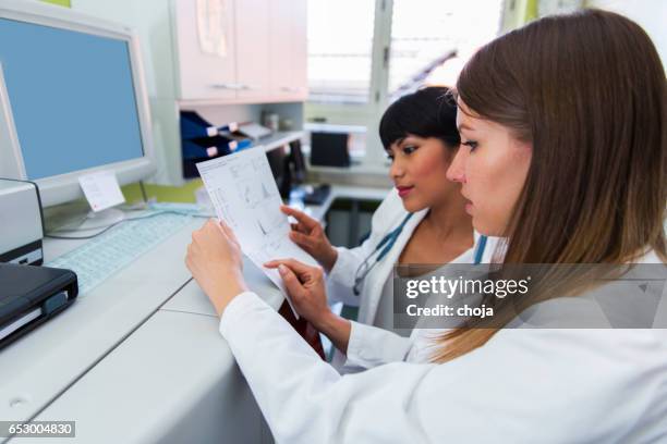 lab scientists in a blood bank checking data - blood group stock pictures, royalty-free photos & images