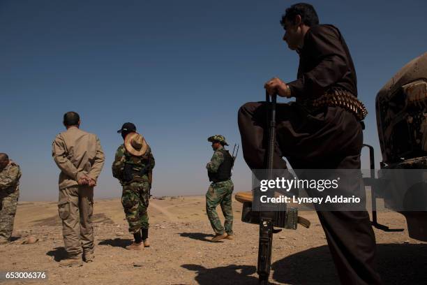 Kurdish Peshmerga forces stand guard on the frontline between Peshmerga and fighters with the Islamic State at a forward operating base between...