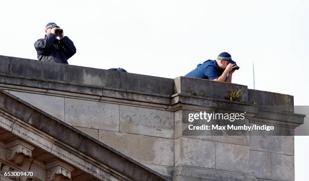 Police spotters on the roof of Buckingham Palace seen during the launch of The Queen's Baton Relay for the XXI Commonwealth Games being held on the...