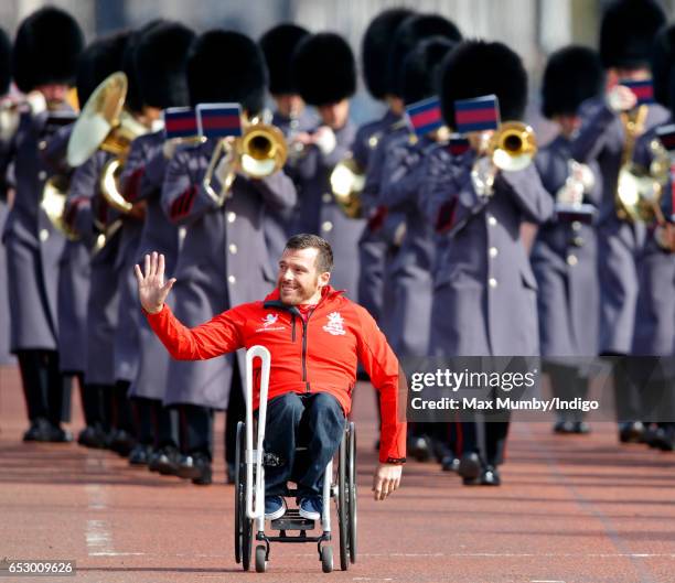 Kurt Fearnley carries The Queen's Baton down The Mall as he attends the launch of The Queen's Baton Relay for the XXI Commonwealth Games being held...