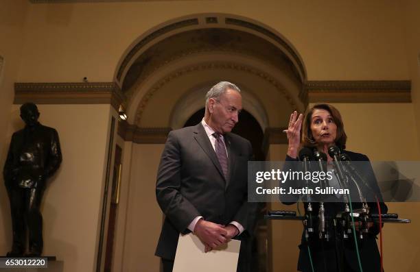 Senate Minority Leader Charles Schumer looks on as House Minority Leader Nancy Pelosi speaks to reporters during a news conference at the U.S....