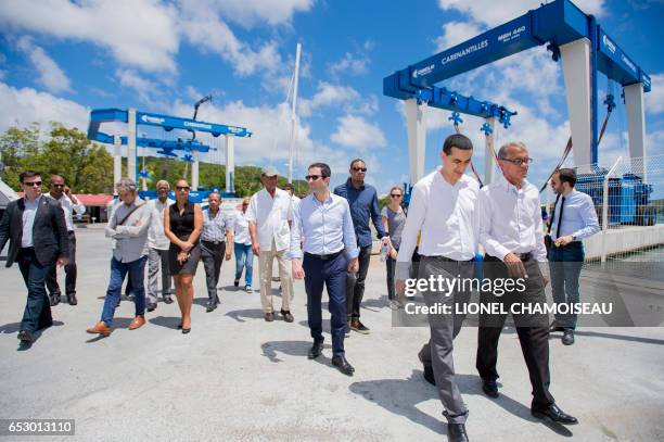 French presidential election candidate for the left-wing Socialist Party Benoit Hamon visits a dry dock in Le Marin on March 13 during a trip to the...