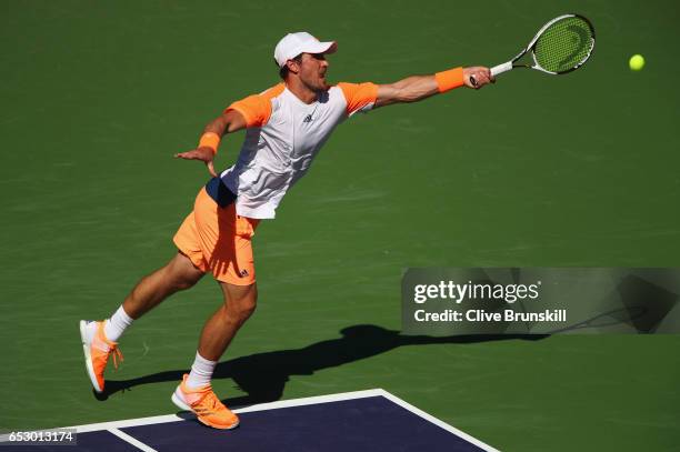 Mischa Zverev of Germany plays a forehand against Dominic Thiem of Austria in their third round match during day eight of the BNP Paribas Open at...