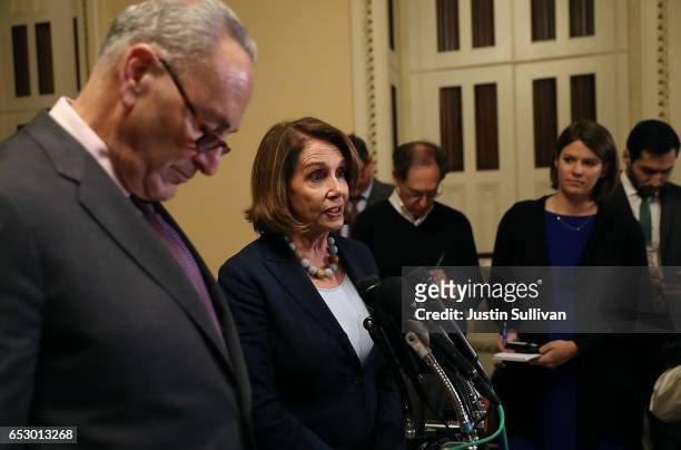 Senate Minority Leader Charles Schumer looks on as House Minority Leader Nancy Pelosi speaks to reporters during a news conference at the U.S....