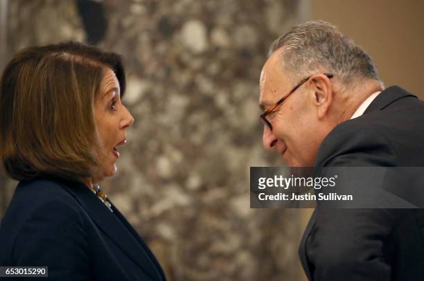 Senate Minority Leader Charles Schumer talks with House Minority Leader Nancy Pelosi following a news conference at the U.S. Capitol on March 13,...