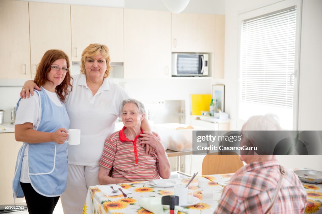 Adult Senior Socializing In The Dining Room Of The Care Center