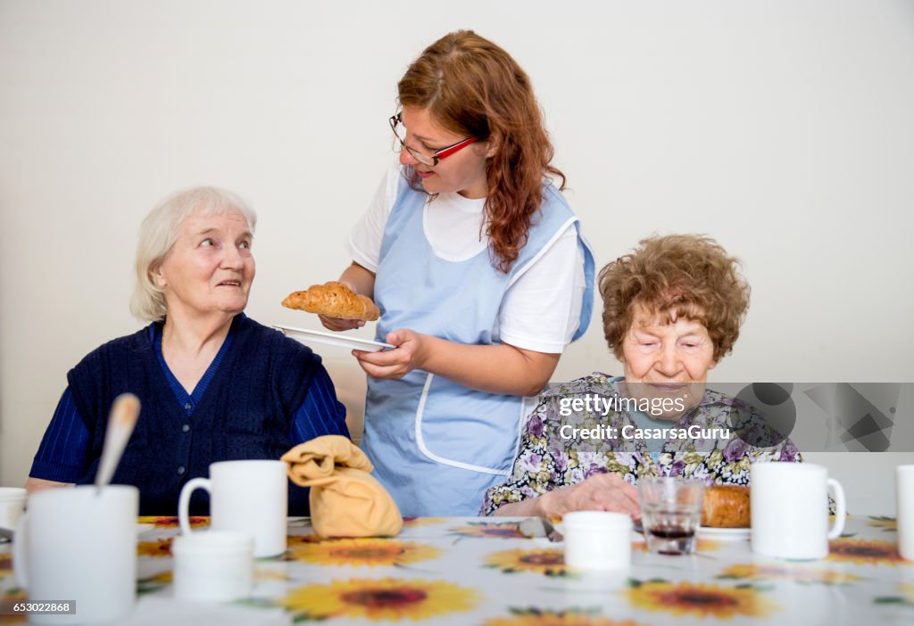 Two Adults Senior Having Breakfast Served