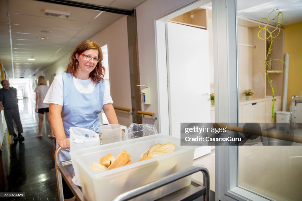 Nurse In The Care Center Preparing Breakfast