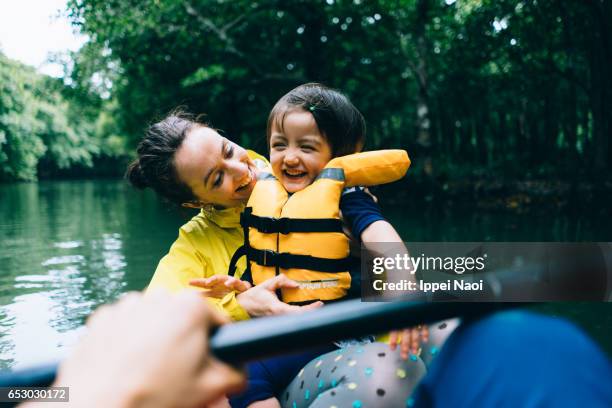 mother and child having fun with mangrove river kayaking - outdoor pursuit 個照片及圖片檔