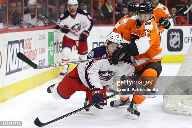 Oliver Bjorkstrand of the Columbus Blue Jackets is checked by Shayne Gostisbehere of the Philadelphia Flyers during the first period at Wells Fargo...