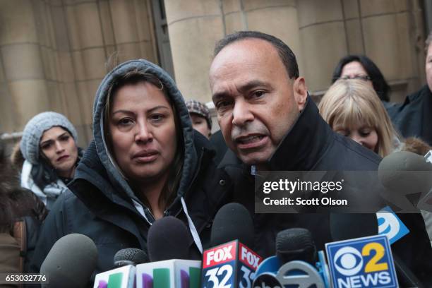 Francisca Lino listens as Rep. Luis Gutierrez speaks to the press after leaving the office of Immigration Services where he was briefly handcuffed...