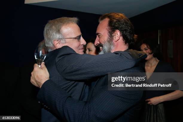 Christophe Lambert and Jean Dujardin attend the "Chacun sa vie" Paris Premiere at Cinema UGC Normandie on March 13, 2017 in Paris, France.