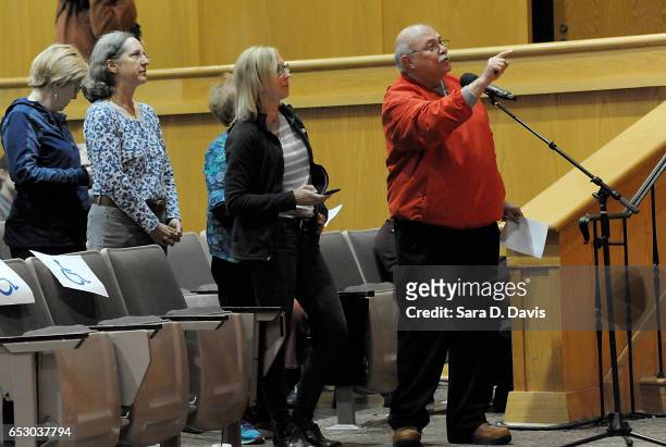 Refugee constituent asked Rep. David Price a question during a town hall meeting at Broughton High School on March 13, 2017 in Raleigh, North...