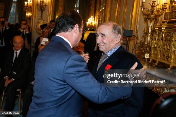 French President, Francois Hollande elevates Claude Brasseur to the rank of "Officier de la Legion d'Honneur" at Elysee Palace on March 13, 2017 in...