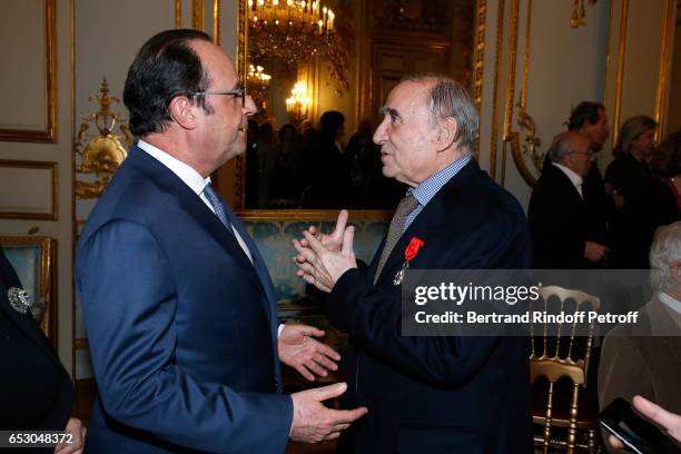 French President, Francois Hollande elevates Claude Brasseur to the rank of "Officier de la Legion d'Honneur" at Elysee Palace on March 13, 2017 in...