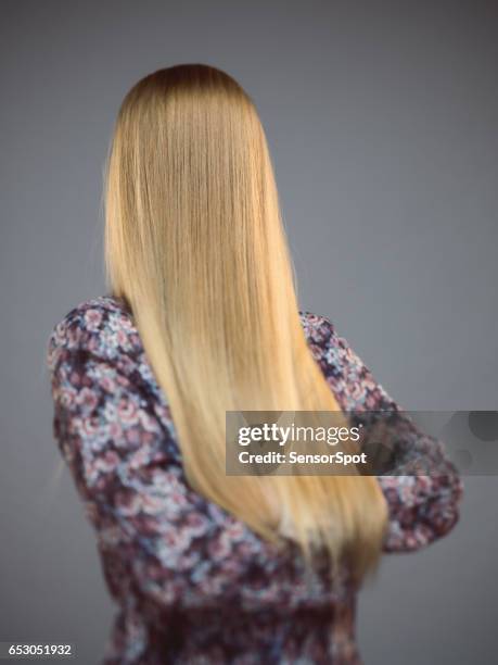 young woman with face covered by long blonde hair - long straight hair stock pictures, royalty-free photos & images