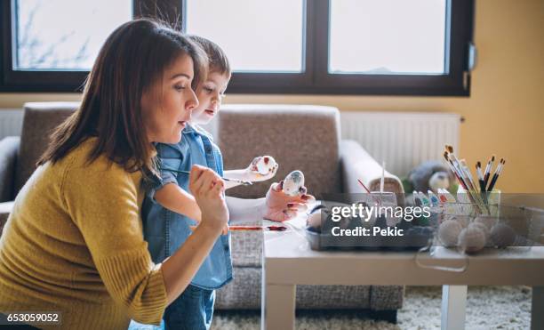 painting eggs with mom - easter egg hunt stock pictures, royalty-free photos & images