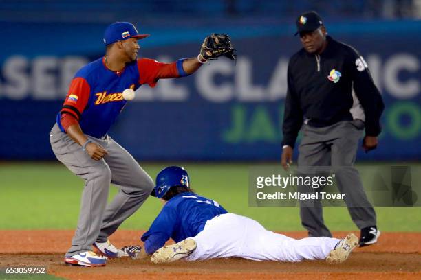 Drew Maggi of Italy slides in second as Alcides Escobar of Venezuela misses a catch in the bottom of the second inning during the World Baseball...