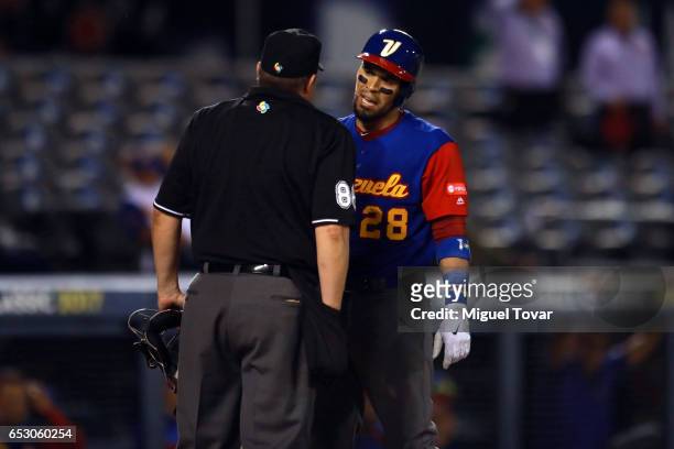 Robinson Chirinos of Venezuela argues with the home plate umpire in the top of the third inning during the World Baseball Classic Pool D Game 7...
