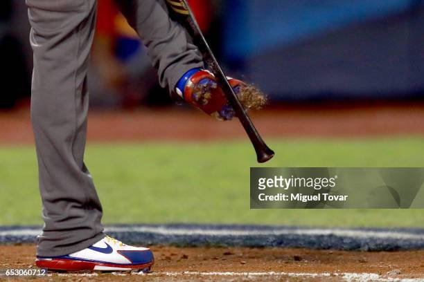 Alcides Escobar of Venezuela removes sand from his shoes in the bottom of the third inning during the World Baseball Classic Pool D Game 7 between...