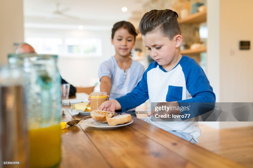 Two happy kids having healthy breakfast.