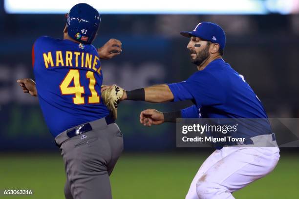 Daniel Descalso of Italy tags out Victor Martinez of Venezuela in the top of the fifth inning during the World Baseball Classic Pool D Game 7 between...