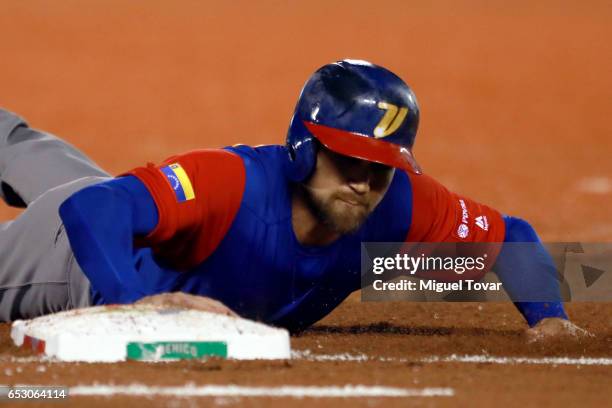 Ender Inciarte of Venezuela slides in first in the top of the fourth inning during the World Baseball Classic Pool D Game 7 between Venezuela and...