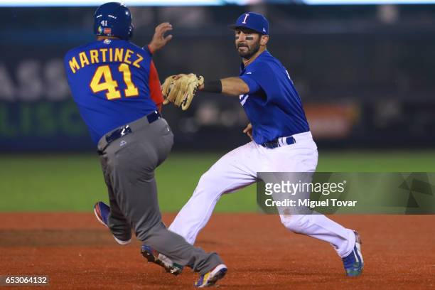 Daniel Descalso of Italy tags out Victor Martinez of Venezuela in the top of the fifth inning during the World Baseball Classic Pool D Game 7 between...