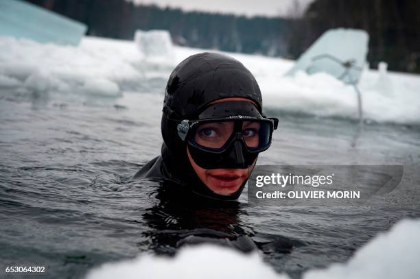 Johanna Nordblad Finnish freediver looks up from the water during a Ice-freediving training session on February 28 in Somero . The ice is about 45cm...