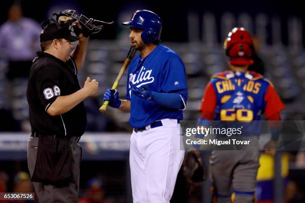 Chris Colabello of Italy talks with home plate umpire after striking out in the bottom of the fifth inning during the World Baseball Classic Pool D...