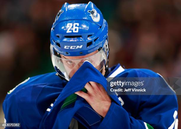 Joseph Cramarossa of the Vancouver Canucks wipes his helmet with his jersey during his NHL game against the Boston Bruins at Rogers Arena March 13,...