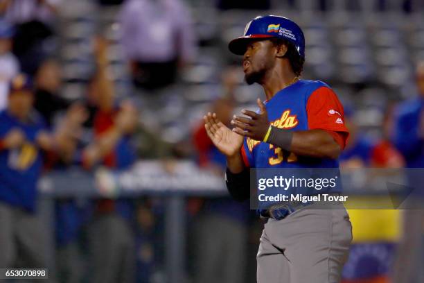 Odubel Herrera of Venezuela celebrates after scoring in the top of the sixth inning during the World Baseball Classic Pool D Game 7 between Venezuela...